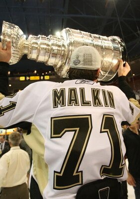 DETROIT - JUNE 12:  Evgeni Malkin #71 of the Pittsburgh Penguins celebrates with the Stanley Cup following the Penguins victory over the Detroit Red Wings in Game Seven of the 2009 NHL Stanley Cup Finals at Joe Louis Arena on June 12, 2009 in Detroit, Mic