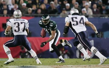 JACKSONVILLE, FLORIDA - FEBRUARY 06:  Wide receiver Todd Pinkston #87 of the Philadelphia Eagles looks for an opening around Rodney Harrison #37 and Tedy Bruschi #54 of the New England Patriots after catching a 17-yard pass against the New England Patriot