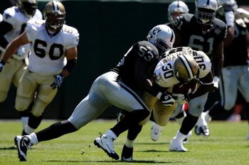 OAKLAND, CA - AUGUST 29:  Linebacker Thomas Howard #53 of the Oakland Raiders tackles Lynell Hamilton #30 of the New Orleans Saints during the preseason game at Oakland-Alameda County Coliseum on August 29, 2009 in Oakland, California. (Photo by Jed Jacob