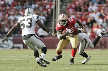 SAN FRANCISCO - AUGUST 22:  San Francisco 49ers tight end Vernon Davis #85 runs as Oakland Raiders linebacker Thomas Howard #53 defends during the 1st quarter as the San Francisco 49ers host the Oakland Raiders at Candlestick Park August 22, 2009 in San F