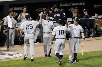 BALTIMORE - AUGUST 31:  Mark Teixeira #25 and Johnny Damon #18 of the New York Yankees are congratulated by Jerry Hairston Jr. #17 and Nick Swisher #33 after scoring in the eighth inning against the Baltimore Orioles on August 31, 2009 at Camden Yards in 
