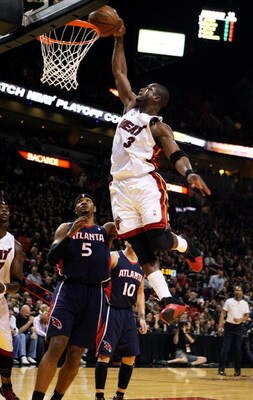 MIAMI - APRIL 25:  Dwyane Wade #3 of the Miami Heat dunks over Josh Smith #5 of the Atlanta Hawks during Game Three of the Eastern Conference Quarterfinals at American Airlines Arena on April 25, 2009 in Miami, Florida. NOTE TO USER: User expressly acknow
