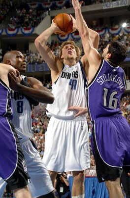 DALLAS - APRIL 24:  Forward Dirk Nowitzki #41 of the Dallas Mavericks takes a jump shot while guarded by Predrag Stojakovic #16 of the Sacramento Kings during Game three of the first round of the NBA Western Conference Playoffs on April 24, 2004 at the Am
