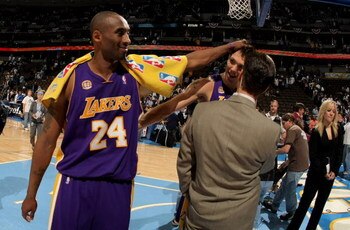 DENVER - APRIL 26:  Kobe Bryant #24 of the Los Angeles Lakers interupts a television interview with teammate Luke Walton #4 after they defeated the Denver Nuggets in Game Three of the Western Conference Quarterfinals during the 2008 NBA Playoffs at the Pe