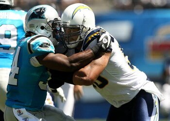 SAN DIEGO - SEPTEMBER 07:  Linebacker Shawne Merriman #56 of the San Diego Chargers fights the block of running back DeAngelo Williams #34 of the Carolina Panthers on September 7, 2008 at Qualcomm Stadium in San Diego, California. The Panthers won 26-24. 