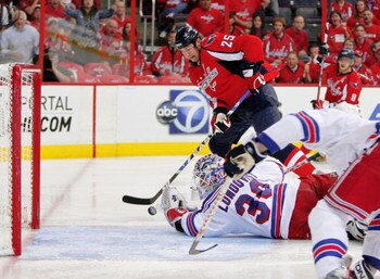 WASHINGTON - APRIL 28:  Viktor Kozlov #25 of the Washington Capitals takes a shot on goal against Henrik Lundqvist #30 of the New York Rangers during Game Seven of the Eastern Conference Quarterfinal Round of the 2009 Stanley Cup Playoffs on April 28, 200