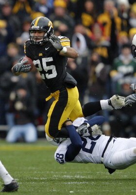 IOWA CITY, IOWA - NOVEMBER 8: Runningback Paki O'Meara #25 of the Iowa Hawkeyes is tackled by defender Drew Astorino #28 of the Penn State Nittany Lions in the first quarter of play at Kinnick Stadium on November 8, 2008 in Iowa City, Iowa. Iowa defeated 