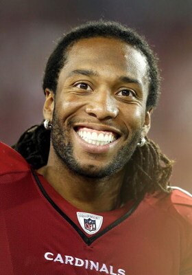 GLENDALE, AZ - AUGUST 22:  Wide receiver Larry Fitzgerald #11 of the Arizona Cardinals smiles on the sidelines during the preseason NFL game against the San Diego Chargers at the Universtity of Phoenix Stadium on August 22, 2009 in Glendale, Arizona. The 
