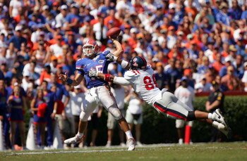 GAINESVILLE, FL - SEPTEMBER 27:  Quarterback Tim Tebow #15 of the Florida Gators is pressured by Greg Hardy #86 of the Ole Miss Rebels during the game at Ben Hill Griffin Stadium on September 27, 2008 in Gainesville, Florida.  (Photo by Sam Greenwood/Gett