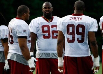 ASHBURN, VA - JULY 30:  Washington Redskins defensive tackle Albert Haynesworth (#92) talks with defensive end Andre Carter (#99) and defensive tackle Cornelius Griffin (#96) during opening day of training camp July 30, 2009 in Ashburn, Virginia.  (Photo 