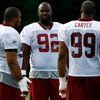 ASHBURN, VA - JULY 30:  Washington Redskins defensive tackle Albert Haynesworth (#92) talks with defensive end Andre Carter (#99) and defensive tackle Cornelius Griffin (#96) during opening day of training camp July 30, 2009 in Ashburn, Virginia.  (Photo 
