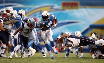 SAN DIEGO - OCTOBER 12:  Runningback LaDainian Tomlinson #21 of the San Diego Chargers runs against the defense of the New England Patriots during the first half of their NFL Game on October 12, 2008 at Qualcomm Stadium in San Diego, California.  (Photo b