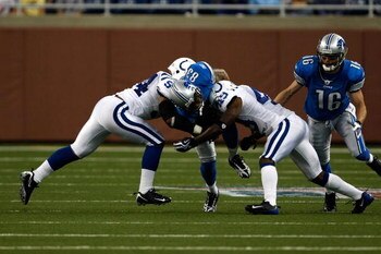DETROIT, MI - AUGUST 28:  Wide receiver Kerry Colbert #83 of the Detroit Lions runs with the football as he is hit by several defenders against the Indianapolis Colts at Ford Field on August 28, 2009 in Detroit, Michigan. The Lions defeated the Colts 18-1