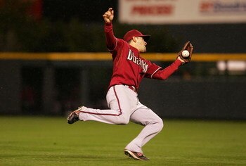 DENVER - OCTOBER 14:  Augie Ojeda #11 of the Arizona Diamondbacks makes a catch on a pop fly off the bat of Garrett Atkins #27 of the Colorado Rockies in the bottom of the fourth inning during Game Three of the National League Championship Series at Coors