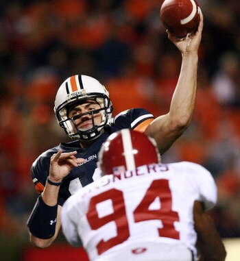 AUBURN, AL - NOVEMBER 24:  Quarterback Brandon Cox #12 of the Auburn Tigers throws a pass over linebacker Keith Saunders #94 of the Alabama Crimson Tide at Jordan-Hare Stadium on November 24, 2007 in Auburn, Alabama. (Photo by Doug Benc/Getty Images)