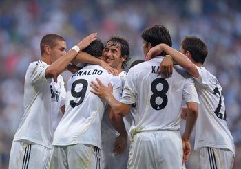 MADRID, SPAIN - AUGUST 29: Cristiano Ronaldo of Real Madrid is congratulated by teammates after scoring a penalty  goal during the La Liga match between Real Madrid and Deportivo La Coruna at the Santiago Bernabeu stadium on August 29, 2009 in Madrid, Spa