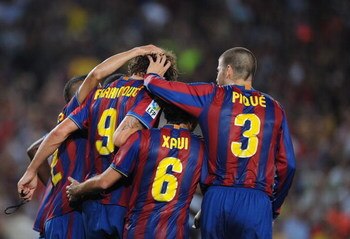 BARCELONA, SPAIN - AUGUST 31:  Zlatan Ibrahimovic  (L) of Barcelona is congratulated by Xavi Hernandez and Gerard Pique after he scored his first goal for Barcelona during the La Liga match between Barcelona and Sporting Gijon at the Nou Camp stadium on A