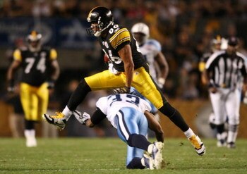 PITTSBURGH - SEPTEMBER 10:  Wide receiver Hines Ward #86 of the Pittsburgh Steelers leaps over safety Michael Griffin #33 of the Tennessee Titans in the second quarter of the NFL season opener at Heinz Field on September 10, 2009 in Pittsburgh, Pennsylvan