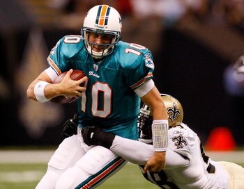 NEW ORLEANS - SEPTEMBER 03:  Quarterback Chad Pennington #10 of the Miami Dolphins is tackled by Sedrick Ellis #99  of the New Orleans Saints at the Louisiana Superdome on September 3, 2009 in New Orleans, Louisiana.  (Photo by Chris Graythen/Getty Images