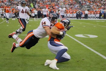 DENVER - AUGUST 30:  Linebacker Brian Urlacher #54 of the Chicago Bears tackles tight end Tony Scheffler #88 of the Denver Broncos during the second quarter at INVESCO Field at Mile High on August 30, 2009 in Denver, Colorado.  (Photo by Doug Pensinger/Ge