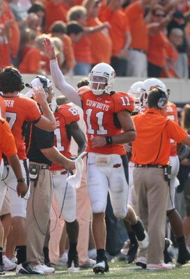 STILLWATER, OK - SEPTEMBER 5: Quarterback Zac Robinson #11 of the Oklahoma State Cowboys celebrates his touchdown in the fourth quarter of the game against the Georgia Bulldogs at Boone Pickens Stadium on September 5, 2009 in Stillwater, Oklahoma. Oklahom