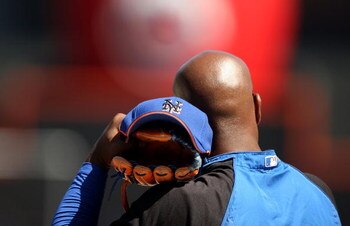 NEW YORK - APRIL 26:  Carlos Delgado #21 of the New York Mets watches batting practice before their game against the Washington Nationals on April 26, 2009 at Citi Field in the Flushing neighborhood of the Queens borough of New York City.  (Photo by Ezra 
