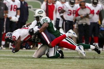 EAST RUTHERFORD, NJ - NOVEMBER 26:  Andre Johnson #80 of the Houston Texans is tackled by Andre Dyson #21 and Erik Coleman #26 of the New York Jets at Giants Stadium on November 26, 2006 in East Rutherford, New Jersey.  (Photo by Chris McGrath/Getty Image