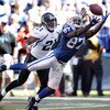 INDIANAPOLIS - SEPTEMBER 13:  Reggie Wayne #87 of the Indianapolis Colts reaches to catch a pass while defended by Derek Cox #21 of the Jacksonville Jaguars during the game at Lucas Oil Stadium on September 13, 2009 in Indianapolis, Indiana.  (Photo by An