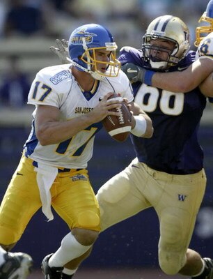 SEATTLE - SEPTEMBER 2:  Quarterback Adam Tafralis #17  of the San Jose State Spartans scrambles against Daniel Te'o Nesheim #66 of the Washington Huskies on September 2, 2006 at Husky Stadium in Seattle, Washington.  (Photo by Otto Greule Jr/Getty Images)