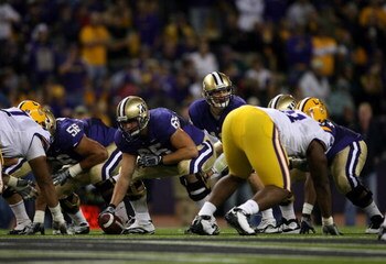SEATTLE - SEPTEMBER 5:  Quarterback Jake Locker #10 of the Washington Huskies gets set behind teammate center Ryan Tolar #65 during their game against the LSU Tigers on September 5, 2009 at Husky Stadium in Seattle, Washington. The LSU Tigers defeated the
