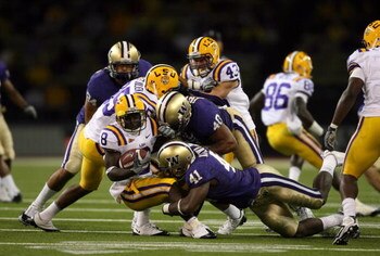 SEATTLE - SEPTEMBER 5:  Mason Foster #40 and Victor Aiyewa #41 of the Washington Huskies tackles Trindon Holliday #8 of the LSU Tigers on September 5, 2009 at Husky Stadium in Seattle, Washington. The LSU Tigers defeated the Washington Huskies 31-23. (Pho