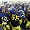ANN ARBOR, MI - SEPTEMBER 05:  Brandon Graham #55 of the Michigan Wolverines leads his teammates in singing the schools fight song after beating the Western Michigan Broncos 31-7 on September 5, 2009 at Michigan Stadium in Ann Arbor, Michigan.  (Photo by 