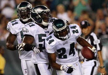 PHILADELPHIA - AUGUST 13:  Sheldon Brown #24 of the Philadelphia Eagles celebrates his interception against the New England Patriots with teammates Chris Clemons #91 and Joe Mays #51 on August 13, 2009 at Lincoln Financial Field in Philadelphia, Pennsylva