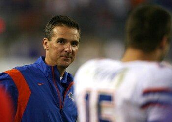 JACKSONVILLE, FL - NOVEMBER 01:  Head coach Urban Meyer smiles toward quarterback Tim Tebow #15 of the Florida Gators after a touchdown in the third quarter against the Georgia Bulldogs at Jacksonville Municipal Stadium on November 1, 2008 in Jacksonville