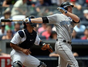NEW YORK - JULY 04: Adam Lind #26 of the Toronto Blue Jays hits a two run home run in the sixth inning against the New York Yankees on July 4, 2009 at Yankee Stadium in the Bronx borough of New York City.  (Photo by Nick Laham/Getty Images)