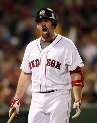 BOSTON - AUGUST 23:  Kevin Youkilis #20 of the Boston Red Sox reacts after he struck out against the New York Yankees on August 23, 2009 at Fenway Park in Boston, Massachusetts.  (Photo by Elsa/Getty Images)