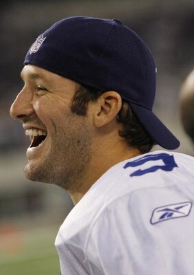 ARLINGTON, TX - AUGUST 21:  Quarterback Tony Romo #9 of the Dallas Cowboys laughs with teammates in the fourth quarter against the Tennessee Titans during a preseason game at Dallas Cowboys Stadium on August 21, 2009 in Arlington, Texas. (Photo by Tom Pen