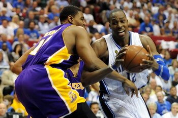 ORLANDO, FL - JUNE 14:  Dwight Howard #12 of the Orlando Magic drives on Andrew Bynum #17 of the Los Angeles Lakers in the third quarter of Game Five of the 2009 NBA Finals on June 14, 2009 at Amway Arena in Orlando, Florida.  NOTE TO USER:  User expressl