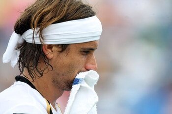 CINCINNATI - AUGUST 20:  David Ferrer of Spain reacts against Roger Federer of Switzerland during day four of the Western & Southern Financial Group Masters on August 20, 2009 at the Lindner Family Tennis Center in Cincinnati, Ohio.  (Photo by Nick Laham/