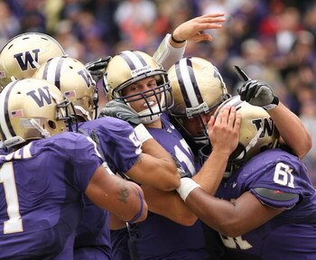SEATTLE - SEPTEMBER 19:  Quarterback Jake Locker #10 of the Washington Huskies is mobbed by teammates after scoring a touchdown against the USC Trojans on September 19, 2009 at Husky Stadium in Seattle, Washington. The Huskies defeated the Trojans 16-13. 