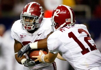 ATLANTA - SEPTEMBER 05:  Running back Mark Ingram #22 of the Alabama Crimson Tide takes a handoff from quarterback Greg McElroy #12 against the Virginia Tech Hokies during the Chick-fil-A Kickoff Game at Georgia Dome on September 5, 2009 in Atlanta, Georg